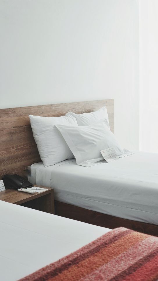 Bright bedroom with freshly made beds